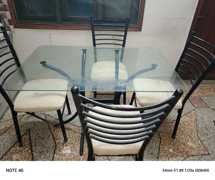 Metal and glass dinning table with four chairs in very good condition. 8