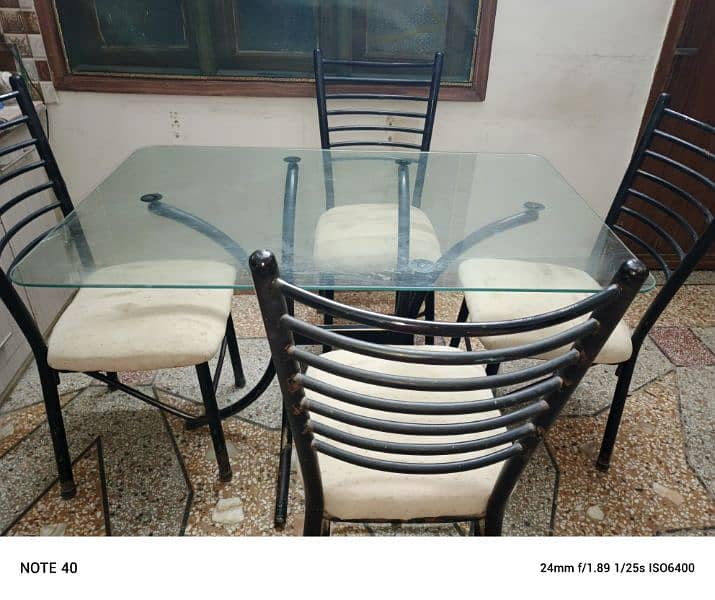 Metal and glass dinning table with four chairs in very good condition. 9