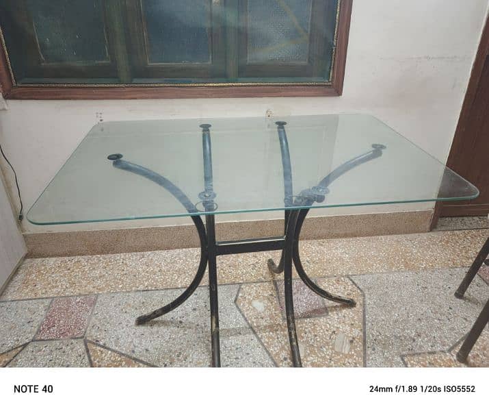 Metal and glass dinning table with four chairs in very good condition. 11