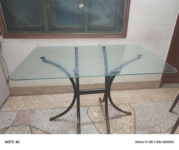 Metal and glass dinning table with four chairs in very good condition. 12