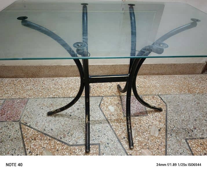 Metal and glass dinning table with four chairs in very good condition. 18