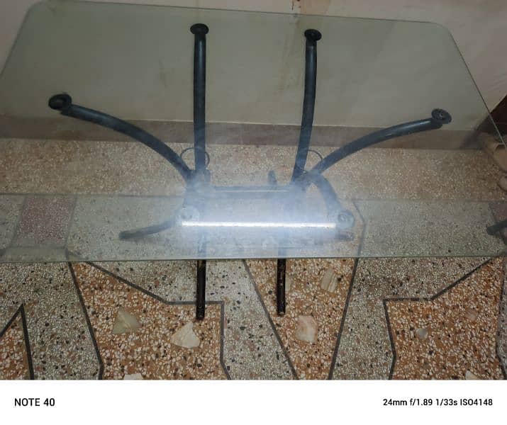 Metal and glass dinning table with four chairs in very good condition. 19
