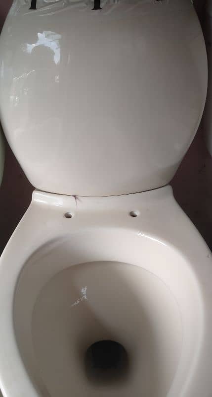 Commode Toilet with seat in off white colour in 9/10 condition 0