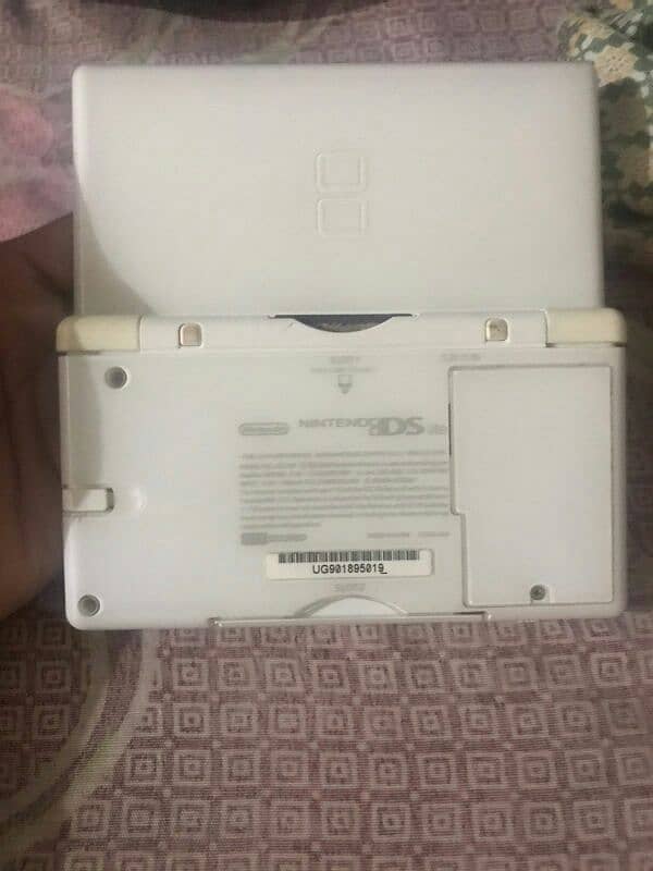 Nintendo DS console with original charger and 2 cards 1