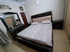 wooden luxury bed set with side tables and dressor