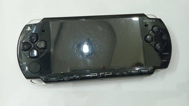 PSP in excellent condition, includes a protective case and charger 1