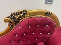 pair of red and fluffy couch with golden lining