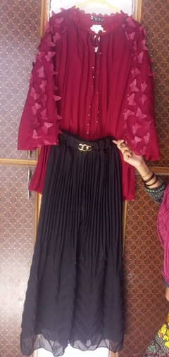 Top,Plazo Maroon and Black colour.