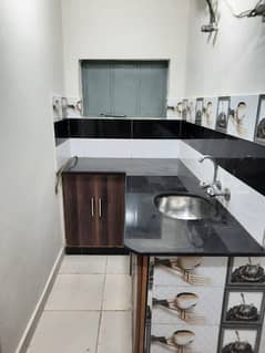 Furnished Independent LDA Flat/ Apartment with Carpeted 2 Rooms for Rent in Q Block Model Town Lahore with AC, Fridge, LED TV, Curtain, Stove, Beds, wood work, UPS, Tiled TV Lounge, Kitchen & bath room Rent = 32000