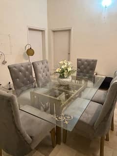 Glass top dining table with 6 velvet chairs