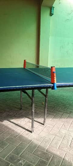 Table Tennis Table with racket, ball and net