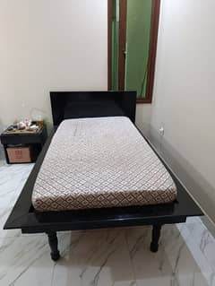 single bed with side table writing table with chair and sofa cumbed