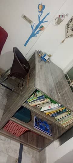 a large study table with drawers and book racks.