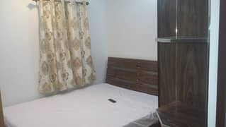 Furnished Independent LDA Flat/ Apartment with Carpeted 2 Rooms for Rent in Q Block Model Town Lahore with AC, Fridge, LED TV, Curtain, Stove, Beds, wood work, UPS, Tiled TV Lounge, Kitchen & bath room Rent = 32000