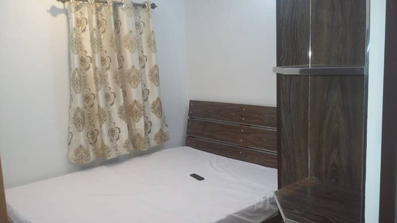 Furnished Independent LDA Flat/ Apartment with Carpeted 2 Rooms for Rent in Q Block Model Town Lahore with AC, Fridge, LED TV, Curtain, Stove, Beds, wood work, UPS, Tiled TV Lounge, Kitchen & bath room Rent = 32000 0