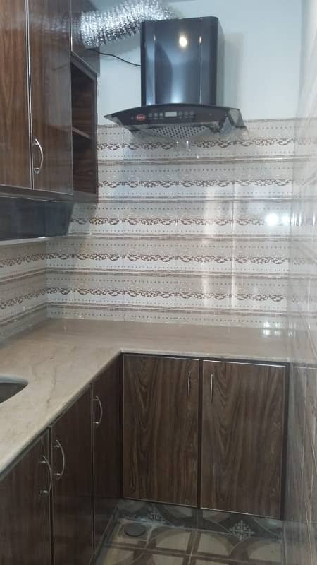 Furnished Independent LDA Flat/ Apartment with Carpeted 2 Rooms for Rent in Q Block Model Town Lahore with AC, Fridge, LED TV, Curtain, Stove, Beds, wood work, UPS, Tiled TV Lounge, Kitchen & bath room Rent = 32000 5