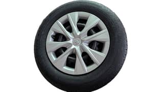 Corolla Bridgestone tyres with wheels and wheel cups.