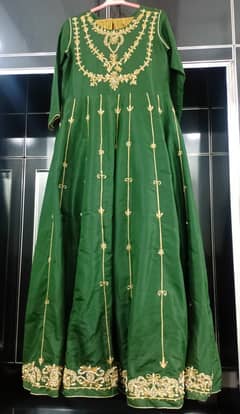 Once used party wear dark green Maxi with stone work