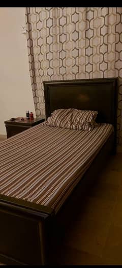 Single bed with mattress and side table