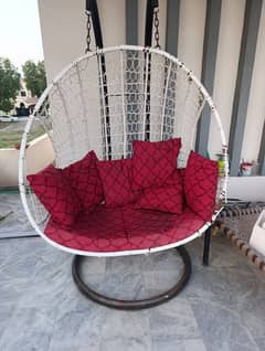 metal swinging chair red cushions