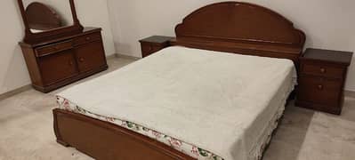 Double king size bed, 2 side tables, dressing table, spring mattress.