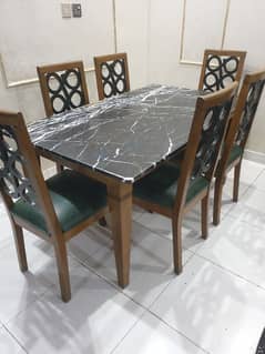 6 seater dining table with marble top and 6 chairs