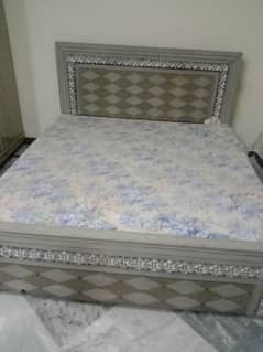 wooden bed in grey colour