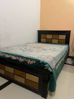 Single wooden bed with mattress