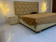 luxury bed with side tables and dressing