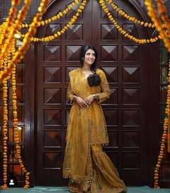 A beautiful gharara 3pc dress in mustard colour from shaposh.