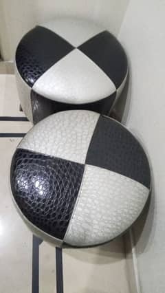 A pair of round stools with leather poshish