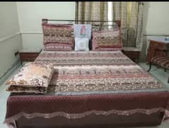 wooden and iron bed with mattress