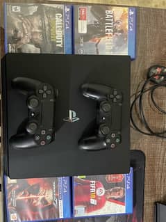 Play Station 4 Pro 1TB with 2 controllers and 4 game CDs