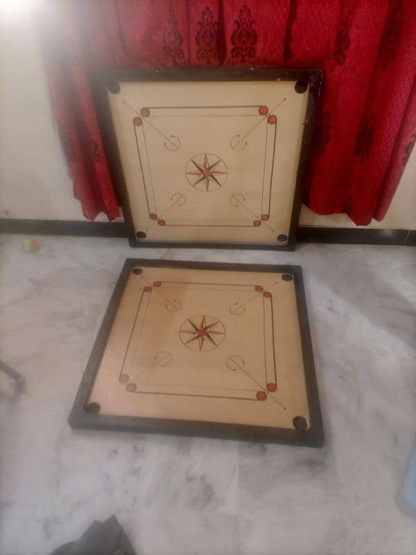 carrom board with coins and striker 0