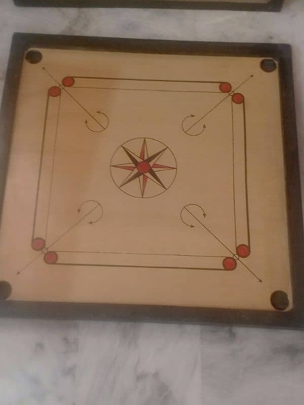 carrom board with coins and striker 2