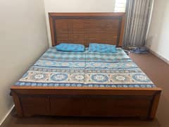 king bed with 2 single mattress and 2 pillows and bed sheet.