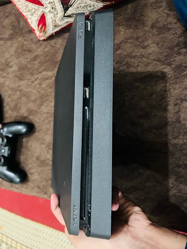 Playstation 4 slim 1TB with 2 original controllers and digital games 10