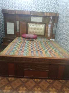 bed with drazz and dressing table