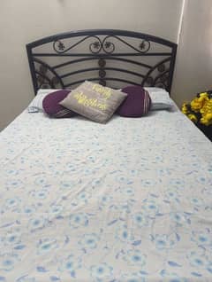 Iron bed for sale in good condition with a new mattress.