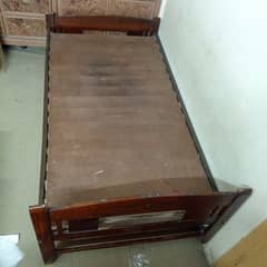 Single wooden bed with mattress