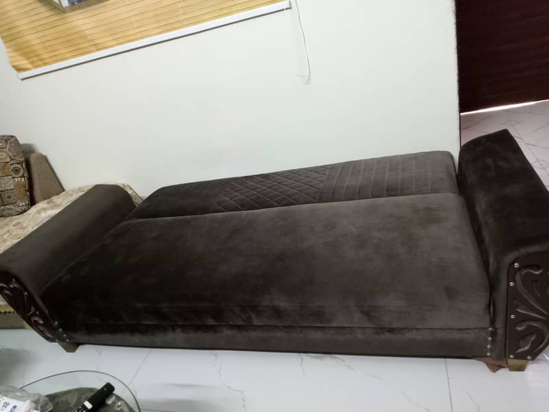 Sofa cum bed in velvet fabric with wooden arms 1
