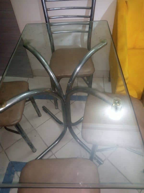 dining table with heavy glass and four Iran chairs 1