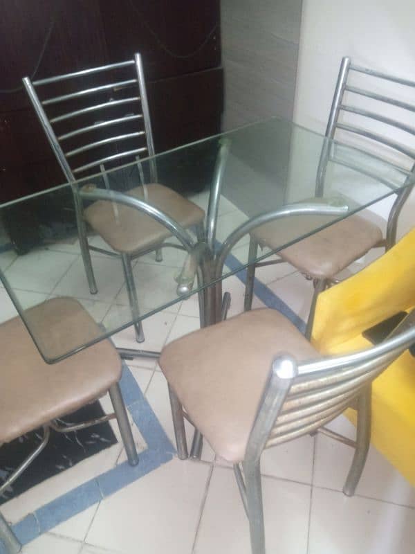 dining table with heavy glass and four Iran chairs 2
