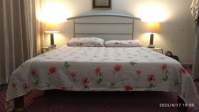 wrought iron bed with round side tables 0