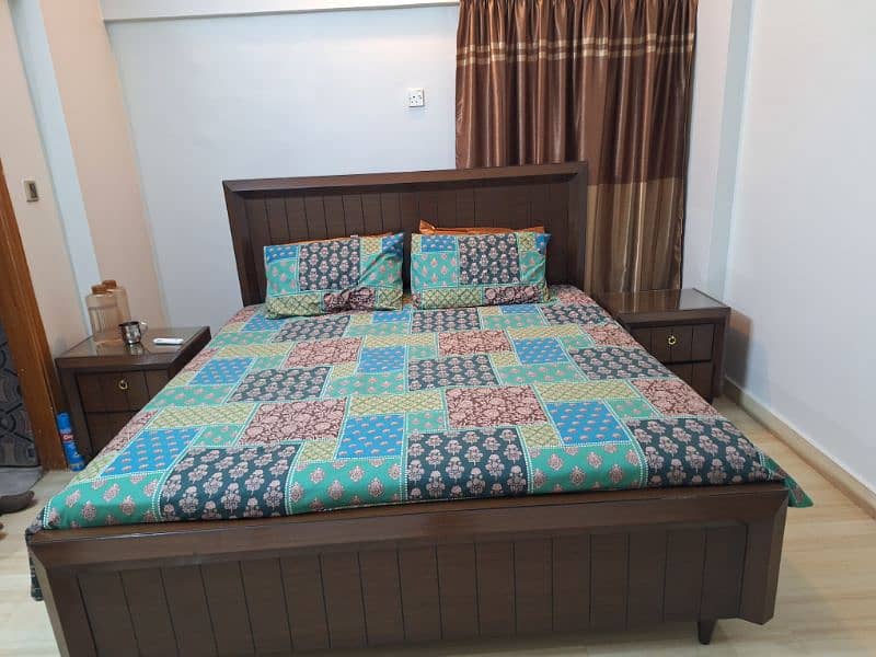 king size bed with two side tables and dressing table 0
