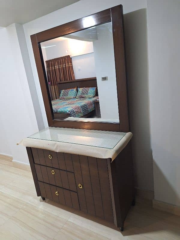 king size bed with two side tables and dressing table 1