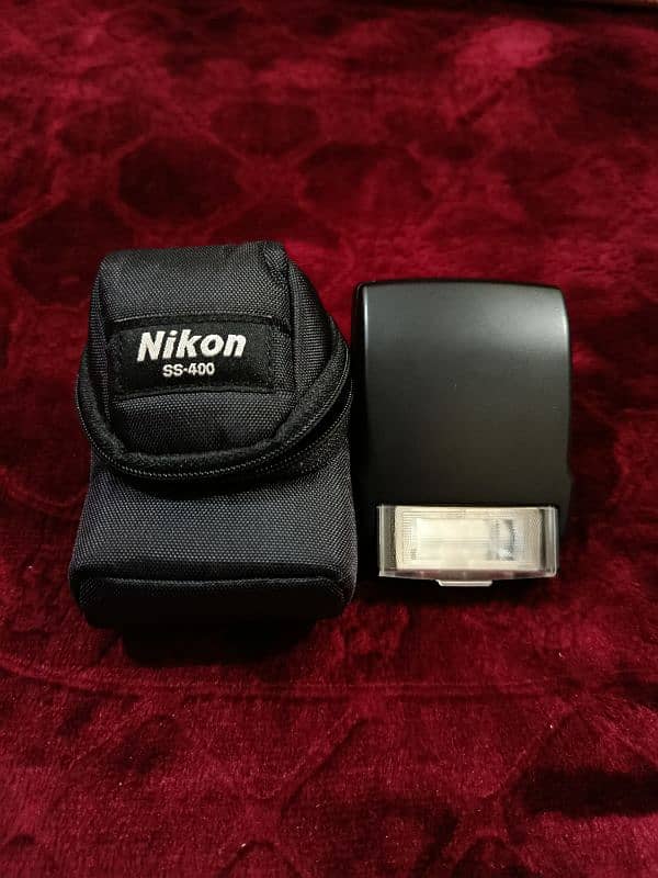 Nikon D5200 with 18-55mm lens + SB 400 Speedlight flash + 16 gb Card 8