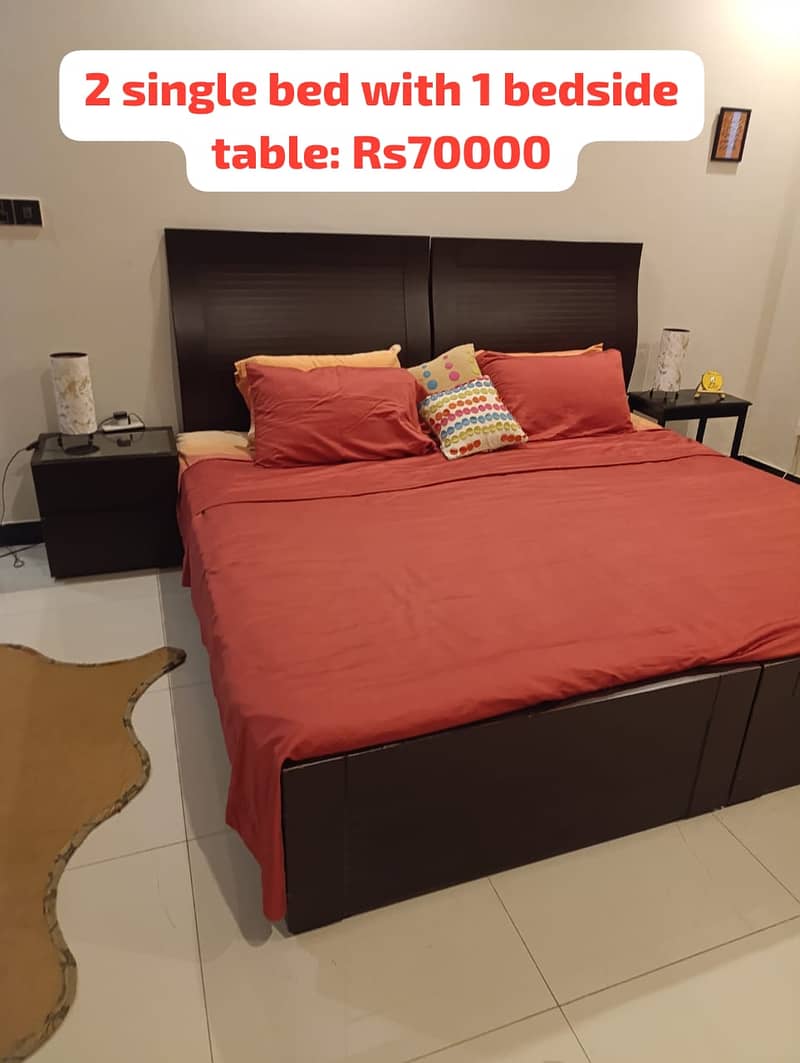 2 single beds with a bedside table 1