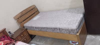 bed with mattress and two side tables