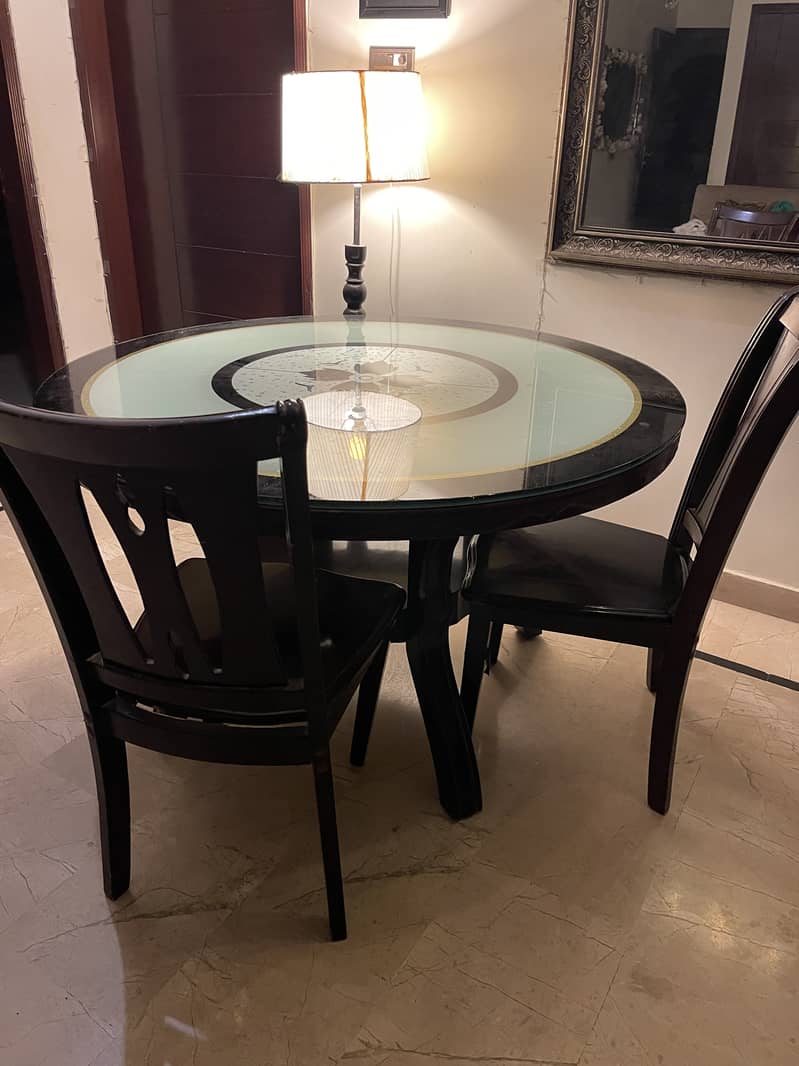 Glass dining table with wooden structure with four chairs 4